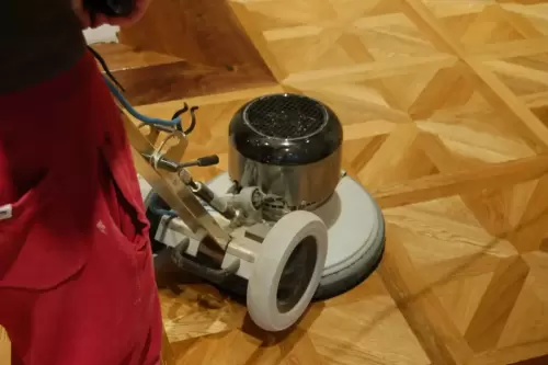 Buffing in Timberex oil on oak parquet